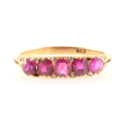 Lot 260 - A synthetic ruby five stone ring.