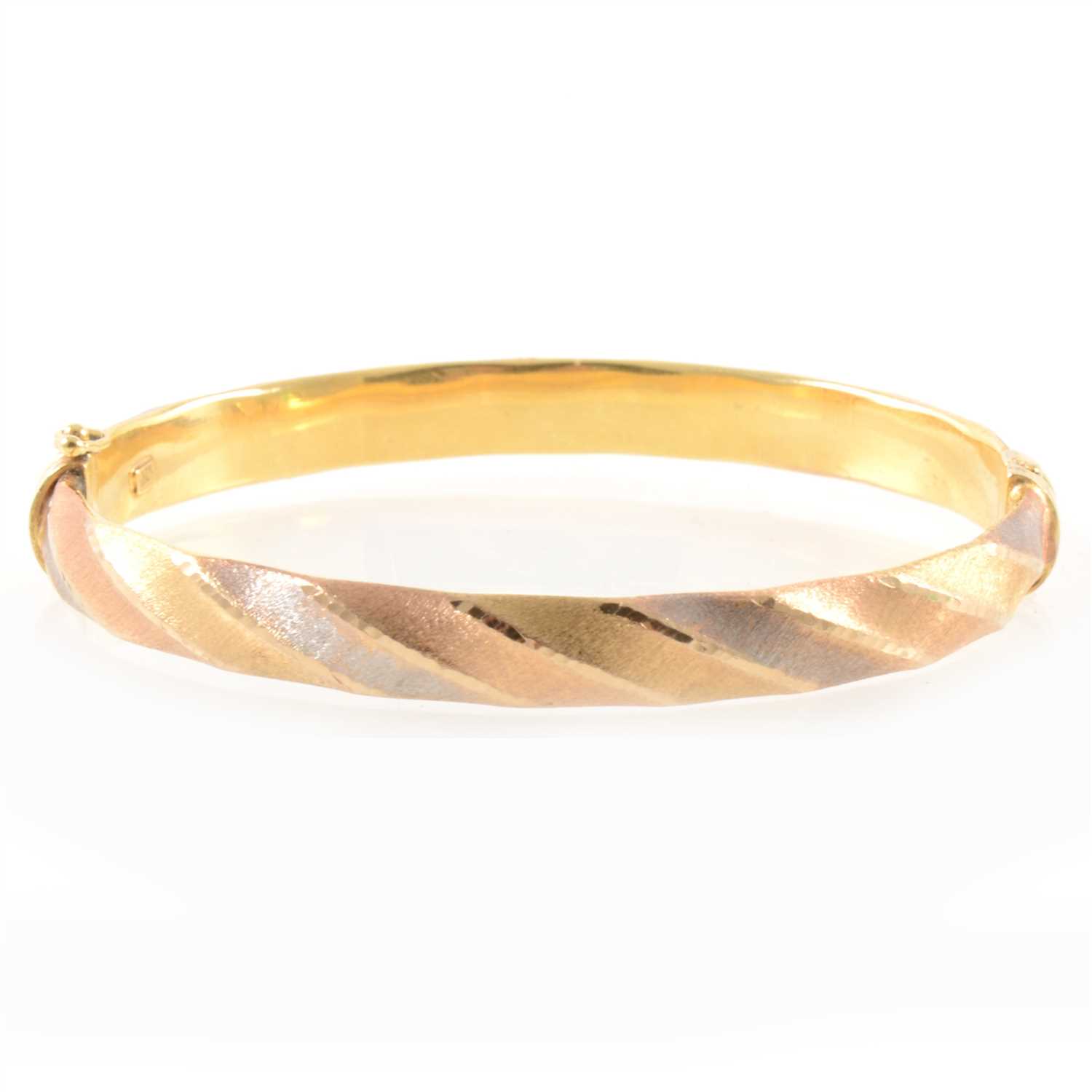 Lot 359 - A tri-colour half hinged bangle.