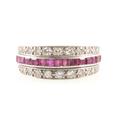 Lot 267 - A ruby, sapphire and diamond full eternity ring, "night and day" style.