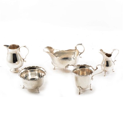 Lot 436 - A silver sauce boat, sugar bowl and three small jugs.