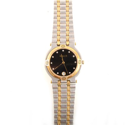Lot 412 - Gucci - a lady's vintage bi-colour bracelet watch with diamond set black dial