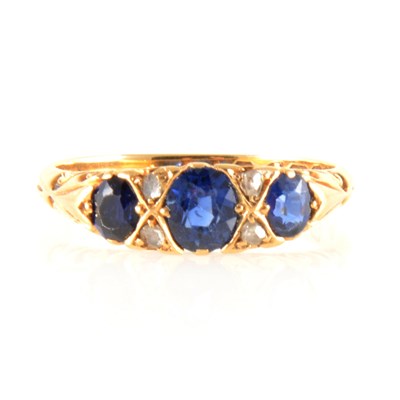 Lot 205 - A synthetic and natural sapphire and diamond ring.