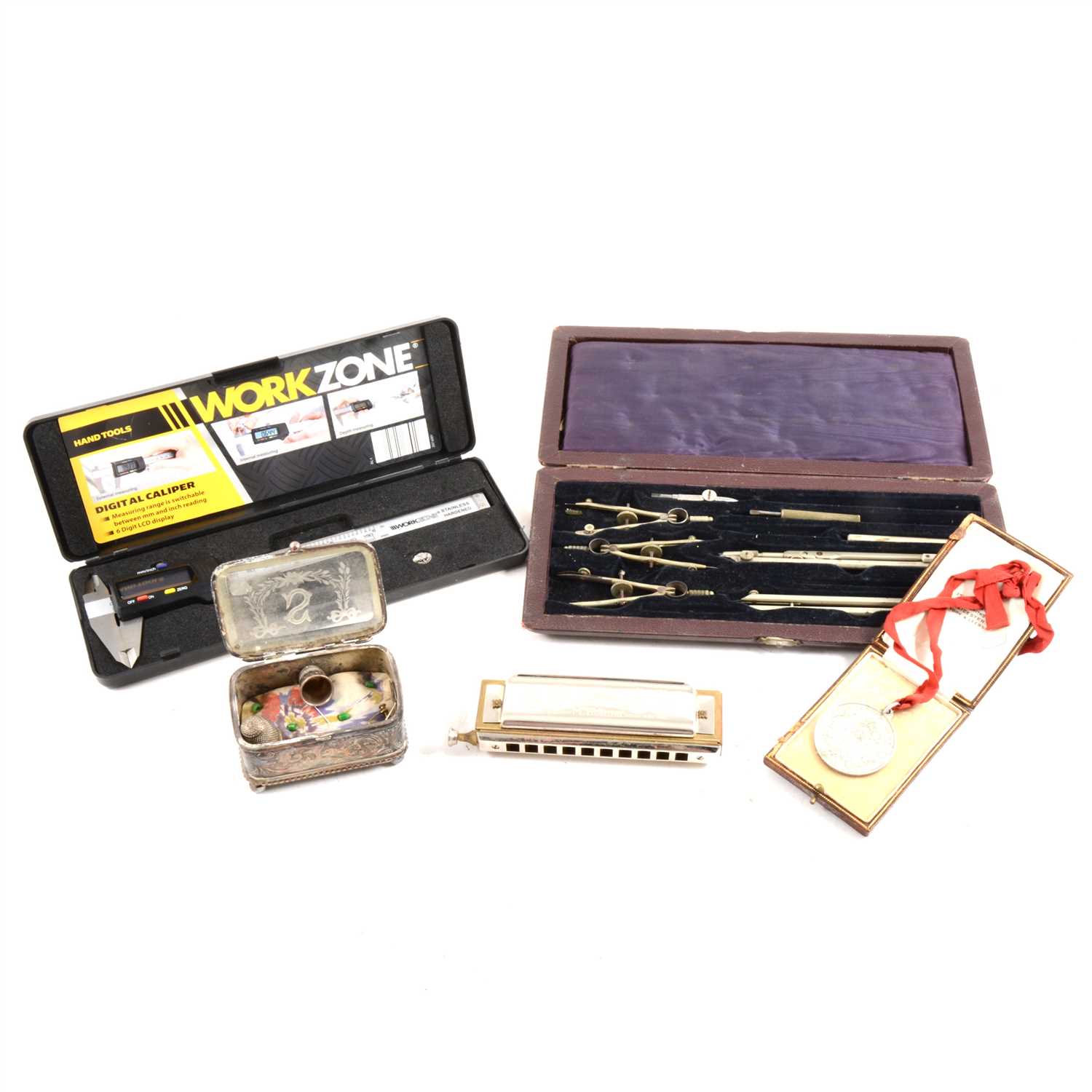 Lot 51 - A box of miscellaneous items, including Hohner Germany Harmonica, drawing set, pair of silver thimbles, watercolour by Alan Godwin, etc.