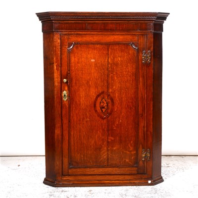 Lot 430 - George III oak mahogany hanging corner cabinet, Greek key cornice, plain frieze, the door with oval shell marquetry, enclosing three fixed shelves, width 86cm, height 111cm.