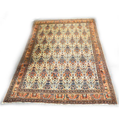 Lot 481 - A Persian rug, with rows of vase motifs on a cream coloured ground, ...