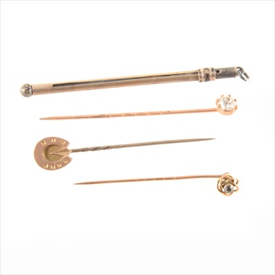 Lot 336 - A silver swizzle stick and three yellow metal tie pins.