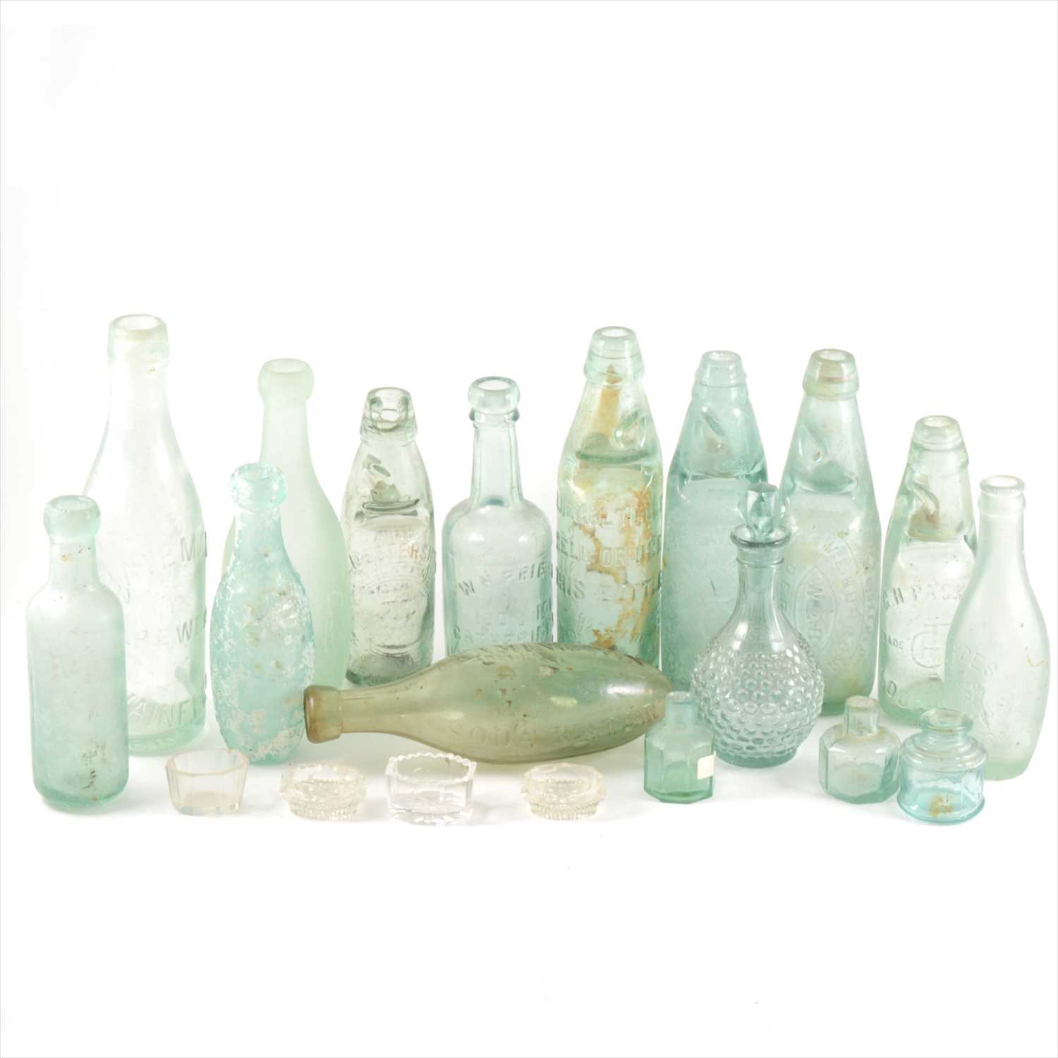Lot 45 - A collection of old green glass cod bottles, other glassware and a stoneware flagon