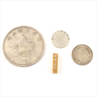 Lot 147 - A Chinese counterfeit Year 3 (1914) Yuan Shih-Kai dollar; two other Chinese coins; and soap stone bar
