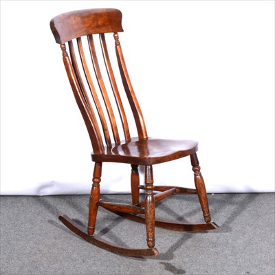 Lot 444 - A stained wood lath back kitchen chair, solid...