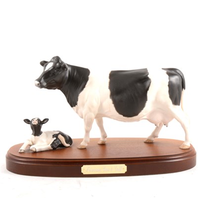 Lot 28 - Royal Doulton, Friesian Cow and Calf, on wooden plinth