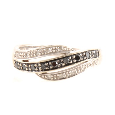 Lot 256 - A white and black diamond crossover ring.