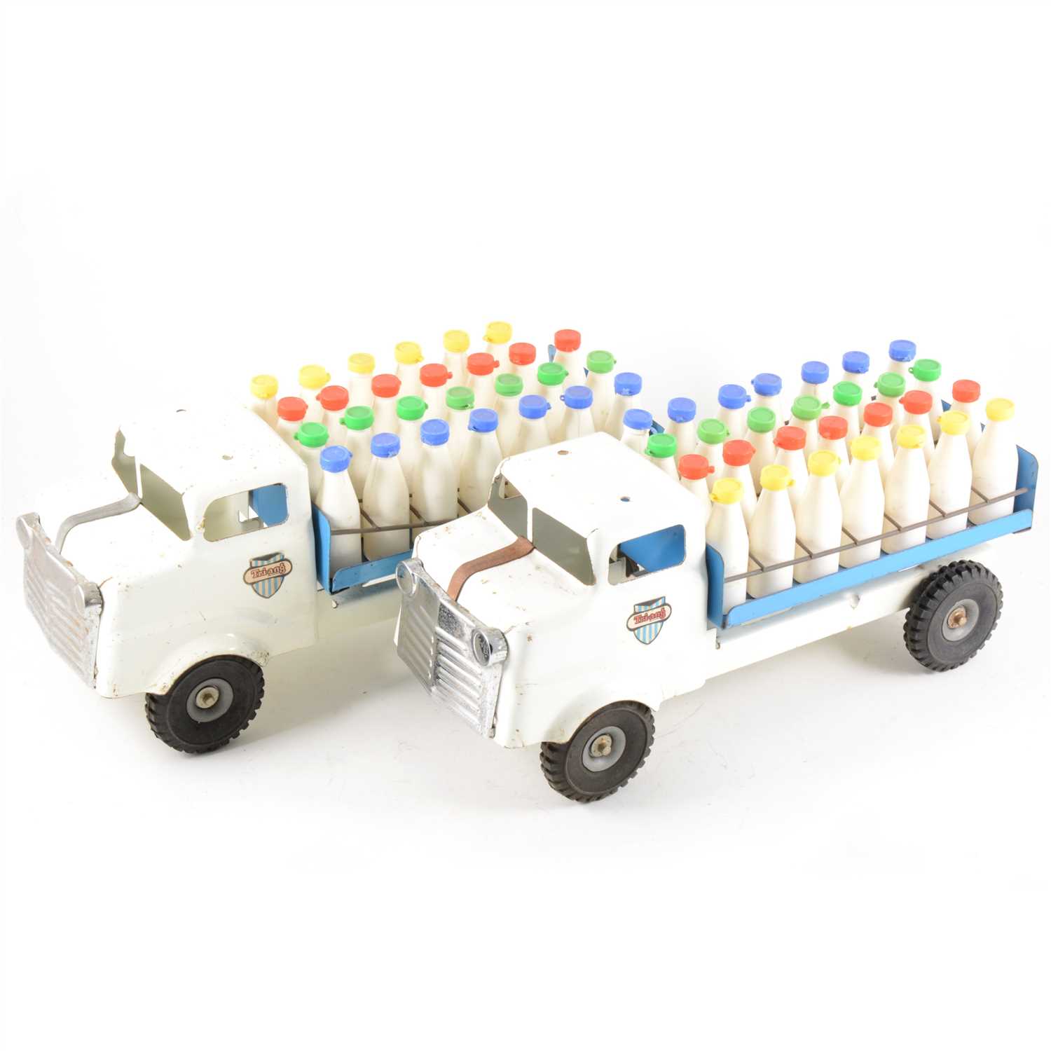 Lot 122 - Tri-ang tin-plate trucks; four including two milk floats with milk bottle