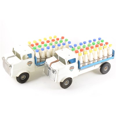 Lot 122 - Tri-ang tin-plate trucks; four including two milk floats with milk bottle