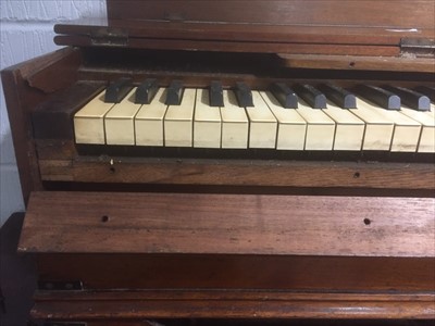 Lot 137 - A walnut and brass banded folding harmonium/ ship's piano