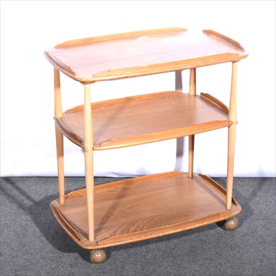 Lot 258 - A three-tier elm trolley, by Ercol.