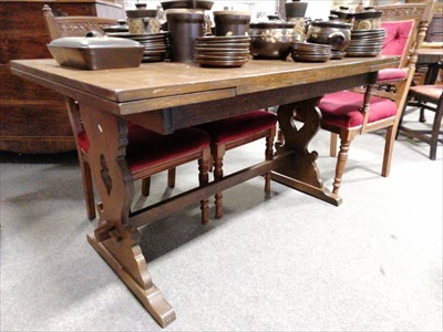 Lot 546 - An oak trestle base dining table, ...