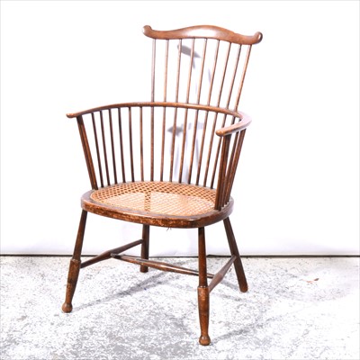 Lot 485 - A beechwood comb-back elbow chair