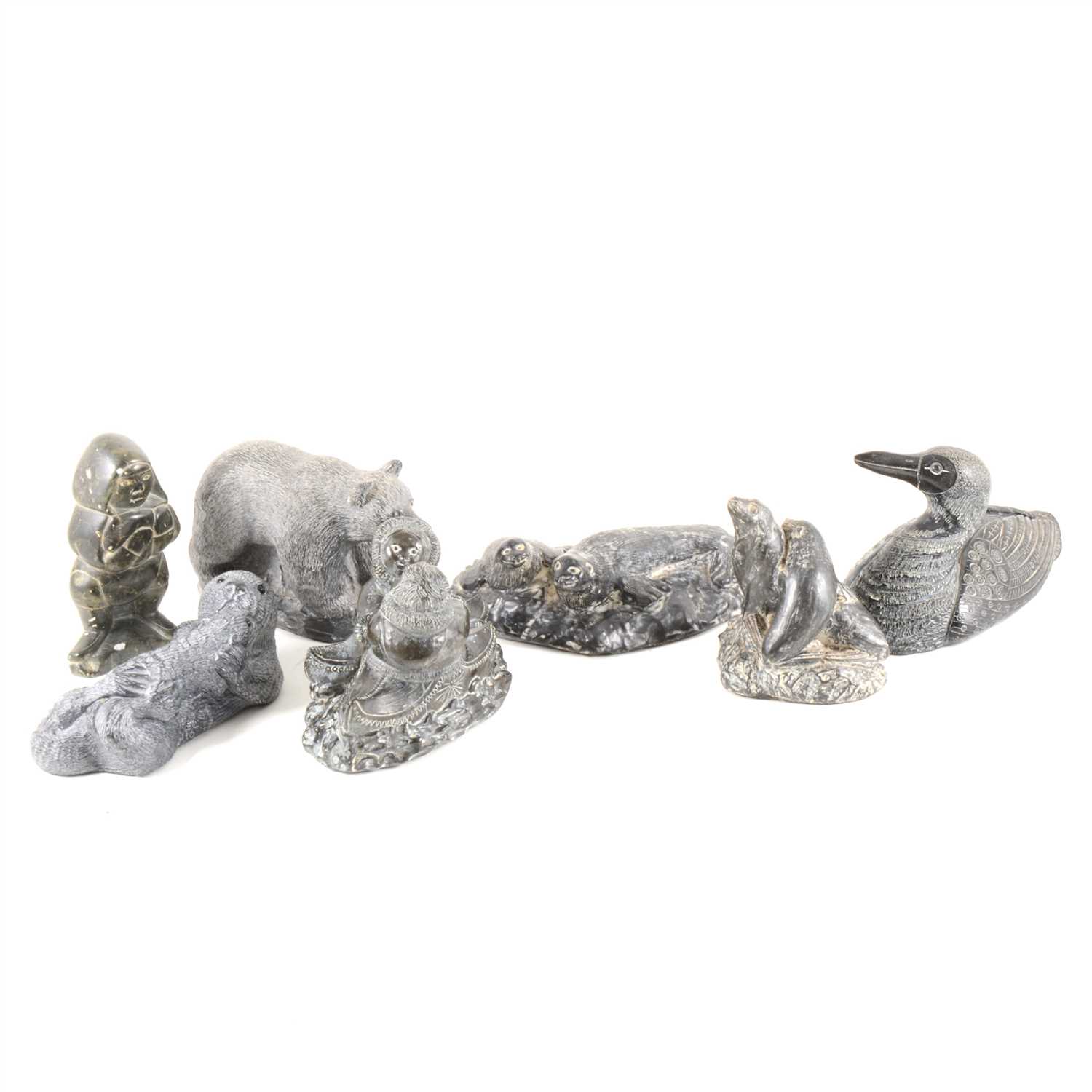 Lot 99 - Thirty Inuit-style carvings and cast resin, one by Levi Smith, others by Wolf and Jonlin, some un-named.