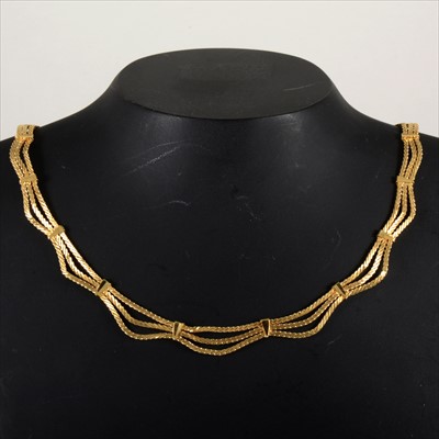 Lot 681 - A 18 carat yellow gold three strand necklace.