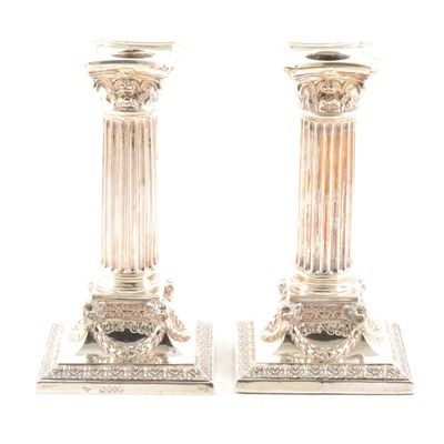 Lot 428 - A pair of small silver Corinthian column candlesticks.