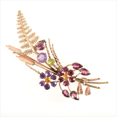Lot 652 - Alabaster & Wilson - a multi gem set brooch in a floral design.