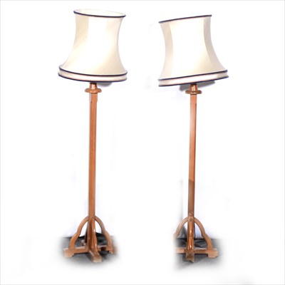 Lot 477 - A pair of pitch pine floor standing lamps