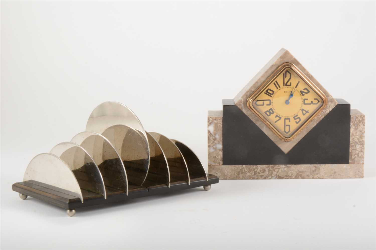 Lot 136 - A small Art Deco marble desk clock and an Art Deco steel toast rack.