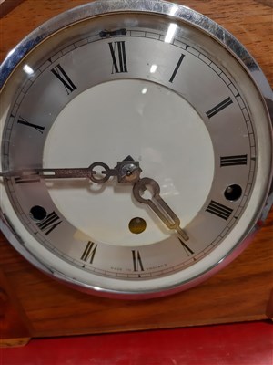 Lot 139 - An Art Deco style mantel clock and a small barometer.