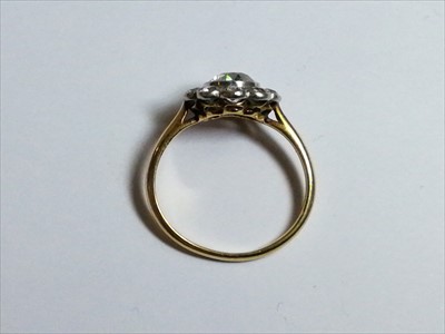 Lot 664 - A diamond circular cluster ring.