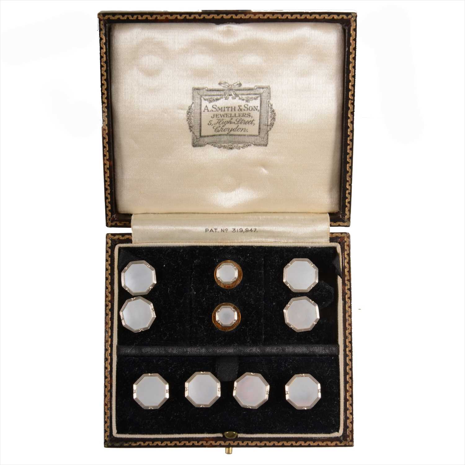 Lot 695 - A cased set of dress studs.