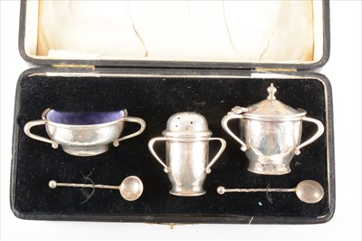 Lot 28 - An Arts and Crafts style cased silver cruet set, by A. E. Jones, Birmingham, 1920