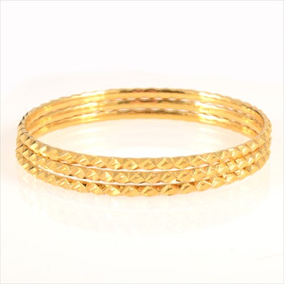 Lot 301 - Three 22 carat yellow gold slave bangles.