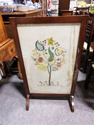 Lot 718 - A stained walnut firescreen, with a needlework panel, width 57cm.