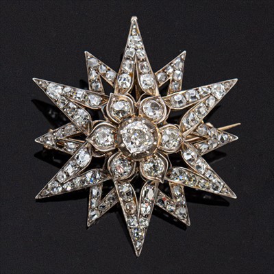 Lot 646 - A Victorian diamond twelve ray star brooch/pendant.
