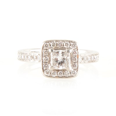 Lot 195 - A princess cut diamond cluster ring.