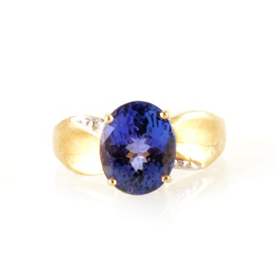 Lot 209 - An oval tanzanite ring and diamond ring.