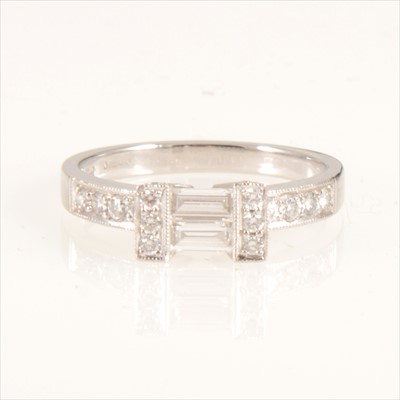 Lot 661 - A diamond baguette cut ring with brilliant cut shoulders.