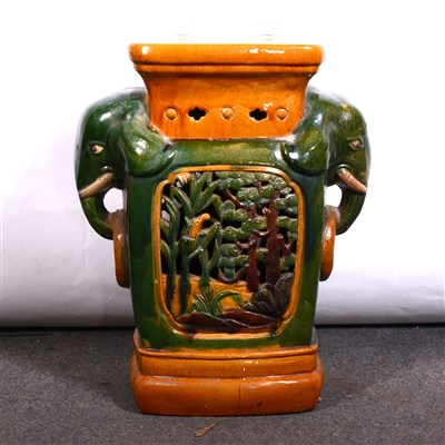 Lot 543 - A glazed elephant seat, green and gold palette.