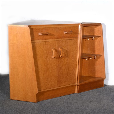 Lot 179 - G-Plan, a Brandon oak free-standing corner cupboard with desk drawer and an extension set of corner shelves.