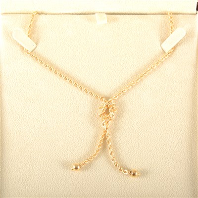 Lot 187 - An 18 carat yellow gold rope design necklace with knot motif.