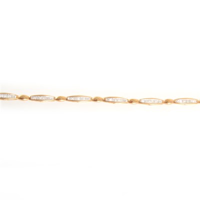 Lot 171 - An 18 carat yellow and white gold diamond line bracelet.