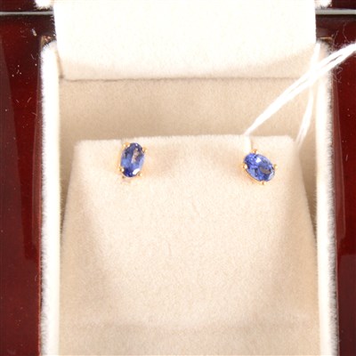 Lot 164 - A pair of tanzanite solitaire earrings.