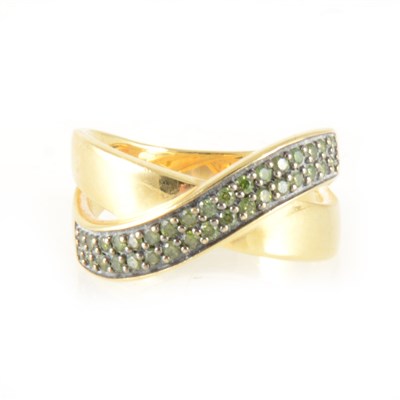 Lot 148 - A green diamond 18 carat gold crossover ring.