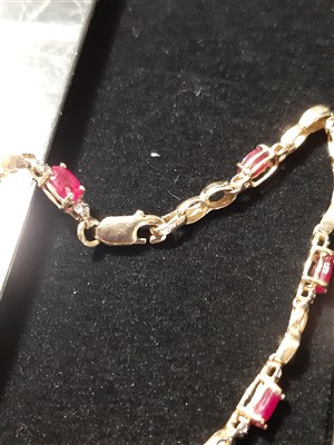 Lot 177 - A Burmese ruby bracelet , a ruby pendant and a yellow metal chain.