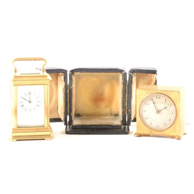 Lot 99 - A miniature brass carriage clock, and a Zenith travel alarm