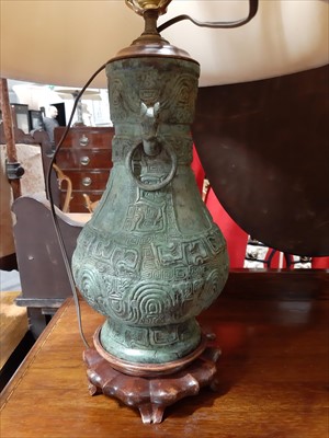 Lot 92 - Large Chinese bronze Hu vase table lamp, with shade and a similar smaller table lamp.