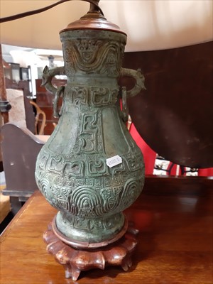 Lot 92 - Large Chinese bronze Hu vase table lamp, with shade and a similar smaller table lamp.