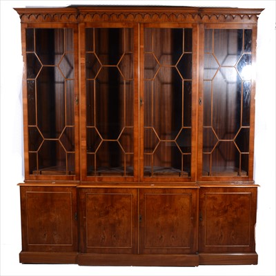 Lot 505 - Reproduction yew wood finish breakfront library bookcase, in George III style