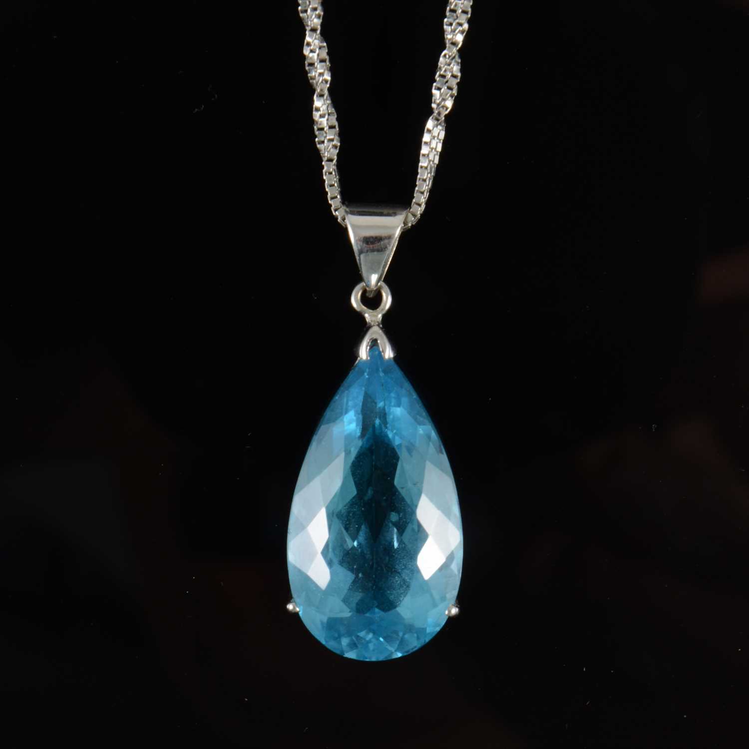 Lot 688 - A synthetic blue topaz pendant and chain.