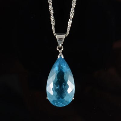 Lot 688 - A synthetic blue topaz pendant and chain.